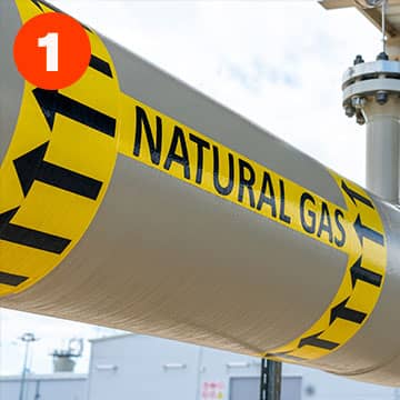 High performance pipe marking label wrapped around an outdoor pipe
