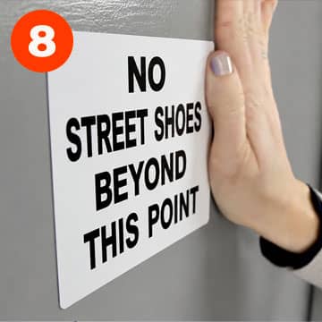 Blank die-cut sign being applied to a wall