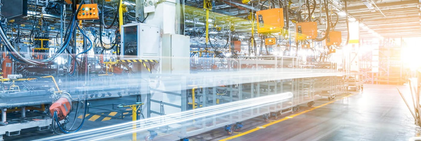 Automated industrial manufacturing facility with production lines, robotics, and factory equipment on the plant floor