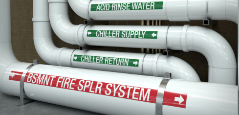 Industrial piping labeled with fire sprinkler system, chiller supply, chiller return, and acid rinse water pipe markers