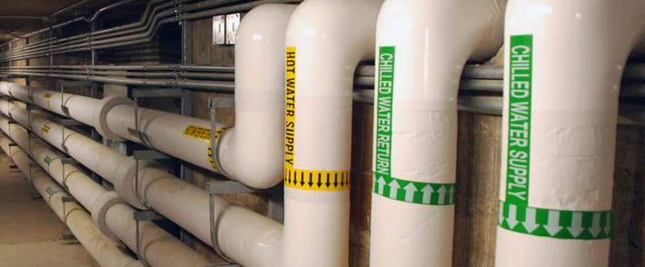 Industrial piping system with clearly labeled pipe markers