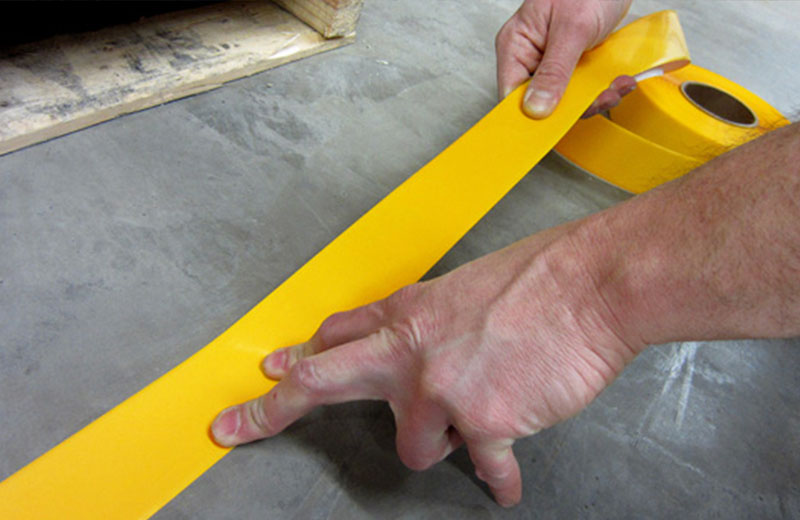Installing Yellow Floor Tape